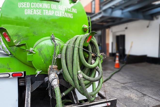 maintenance crew pumping grease trap at a fast food restaurant in Allston MA